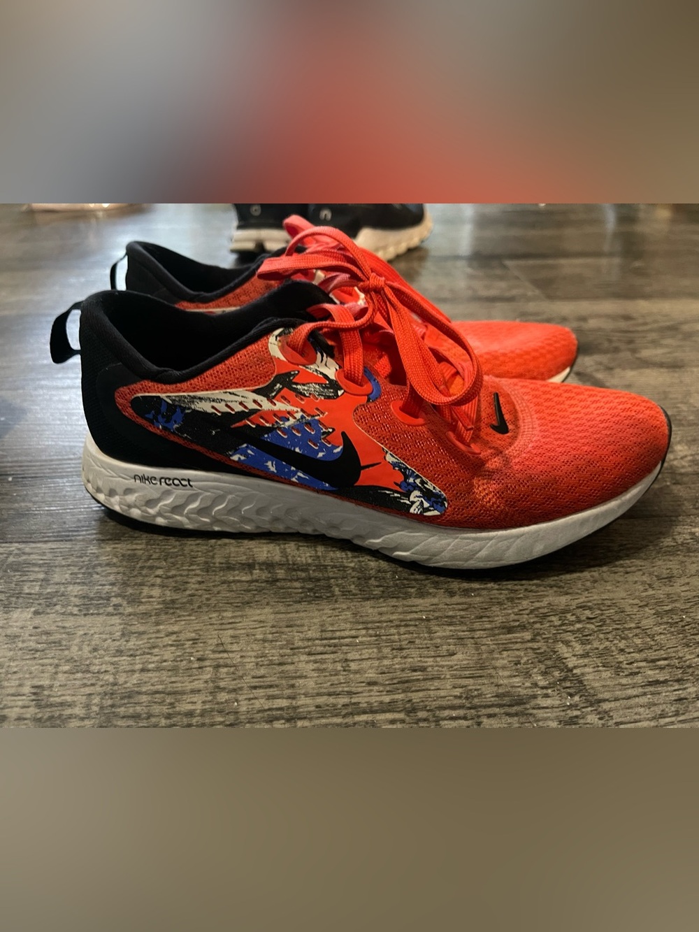 Nike Legend React running shoes in the "Floral - Team Orange" colorway